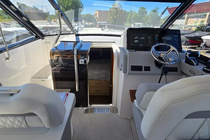 Slide: The Image of 2024 Regal 36 XO boat interior with modern helm and seating. - 25