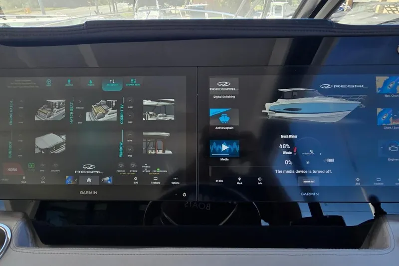 Slide: The Image of 2024 Regal 36 XO boat dashboard with Garmin digital displays showing controls and settings. - 29