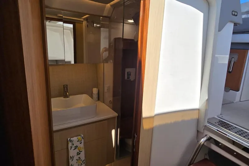 Slide: The Image of Luxurious bathroom interior of 2024 Regal 36 XO yacht, featuring modern sink and cabinetry. - 31