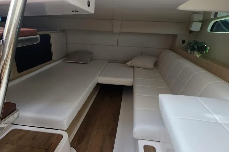 Slide: The Image of Luxurious interior of 2024 Regal 36 XO yacht with white seating and wooden flooring. - 33