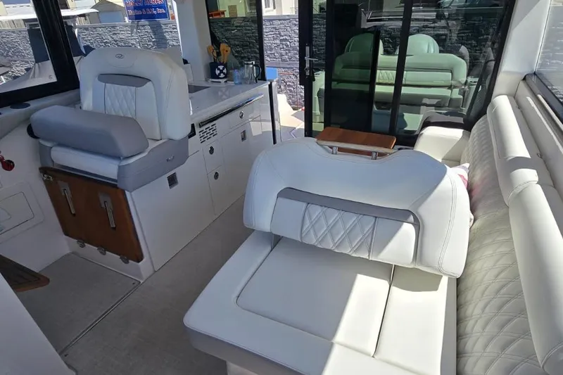Slide: The Image of Luxurious interior of 2024 Regal 36 XO yacht with white leather seating and modern design. - 35