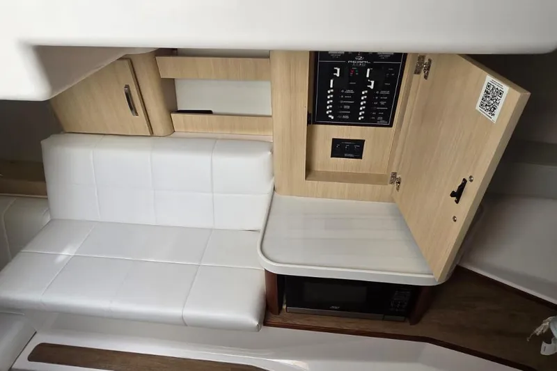 Slide: The Image of 2024 Regal 36 XO interior with white seating, control panel, and microwave. - 37