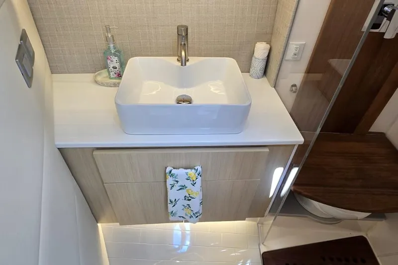 Slide: The Image of Modern bathroom vanity on 2024 Regal 36 XO yacht with vessel sink and elegant decor. - 39