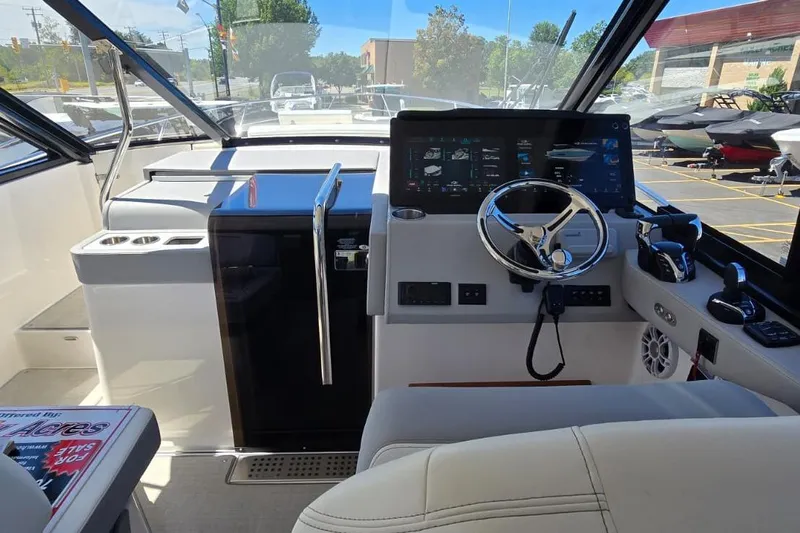 Slide: The Image of 2024 Regal 36 XO boat cockpit with modern controls and steering wheel. - 40