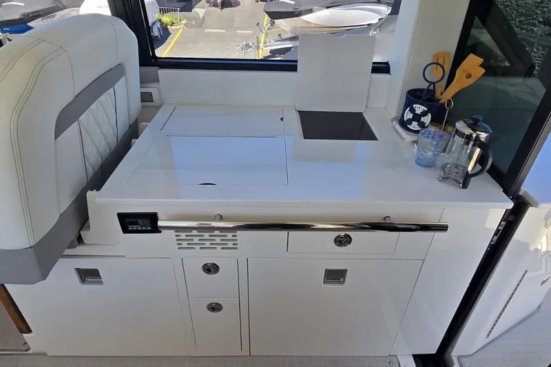Slide: The Image of 2024 Regal 36 XO yacht interior with sleek kitchenette and modern amenities. - 41
