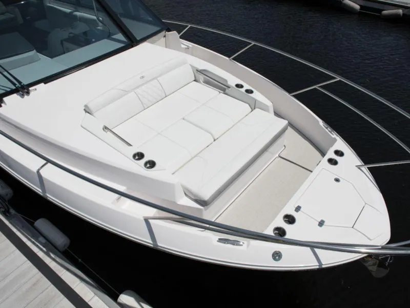 Slide: The Image of 2024 Regal 36 XO boat with vibrant pink underwater lighting at night. - 6