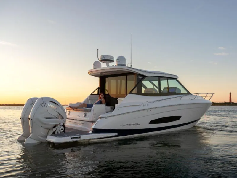 Slide: The Image of 2024 Regal 36 XO boat docked with twin Yamaha outboard engines. - 7