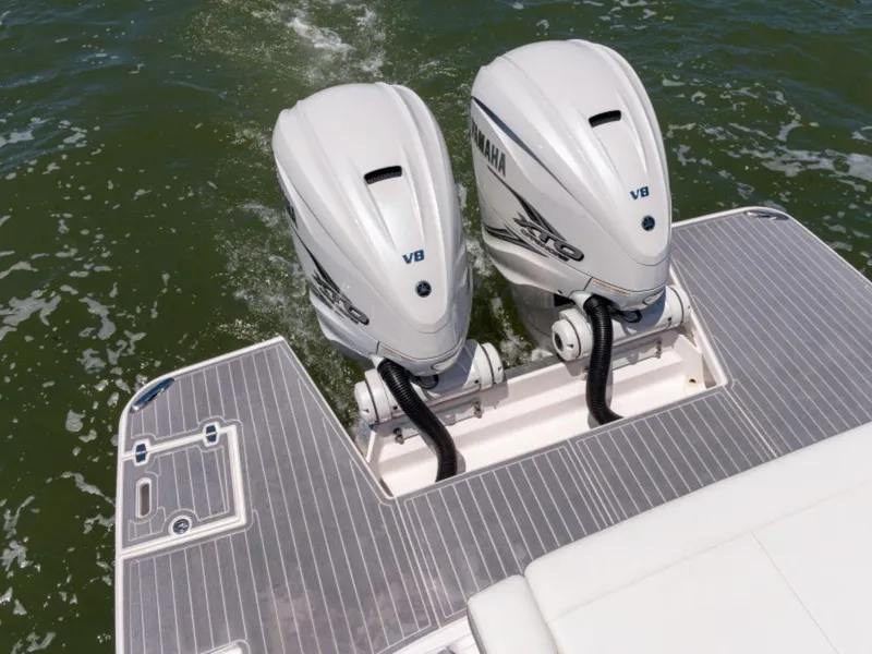 Slide: The Image of 2024 Regal 36 XO boat with dual outboard engines docked at marina. - 8
