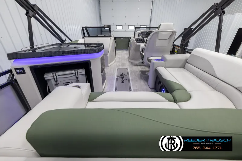 Slide: The Image of 2024 Avalon LSZ ELW boat interior with luxurious seating and modern dashboard. - 17