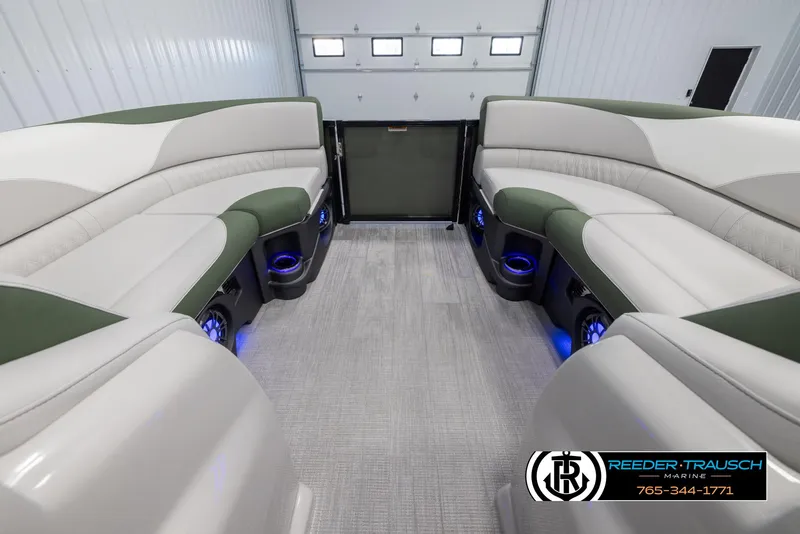 Slide: The Image of 2024 Avalon LSZ ELW pontoon boat interior with plush seating and blue LED lighting. - 19
