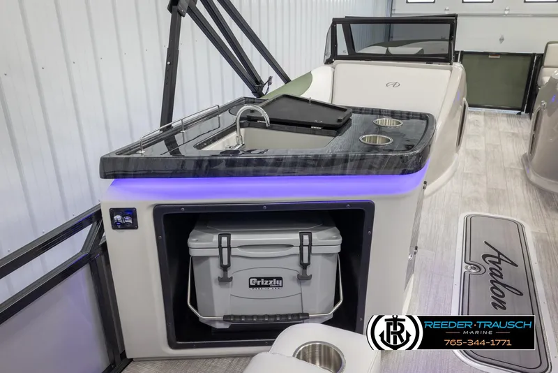 Slide: The Image of 2024 Avalon LSZ ELW boat interior with sink, cooler, and cup holders. - 27
