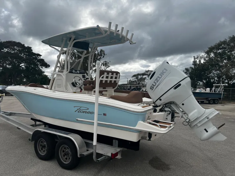 Slide: The Image of 2024 Pioneer 202 Islander boat with Suzuki outboard motor on trailer. - 2