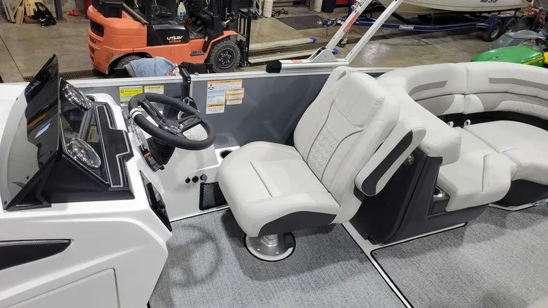 Slide: The Image of 2024 Hurricane Fundeck 2360 SBC OB boat interior with steering console and seating. - 2