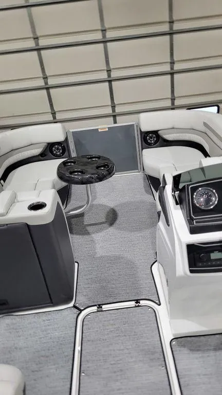 Slide: The Image of 2024 Hurricane Fundeck 2360 SBC OB interior with seating and steering wheel. - 6