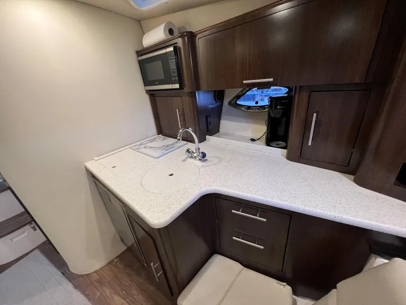 Slide: The Image of 2017 Regal 35 Sport Coupe kitchen area with modern appliances and sleek cabinetry. - 11
