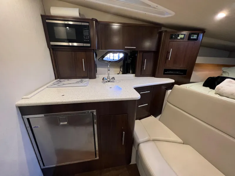 Slide: The Image of Interior of 2017 Regal 35 Sport Coupe with kitchenette and seating area. - 12