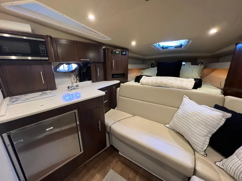 Slide: The Image of Interior of 2017 Regal 35 Sport Coupe with modern kitchen and cozy seating area. - 13