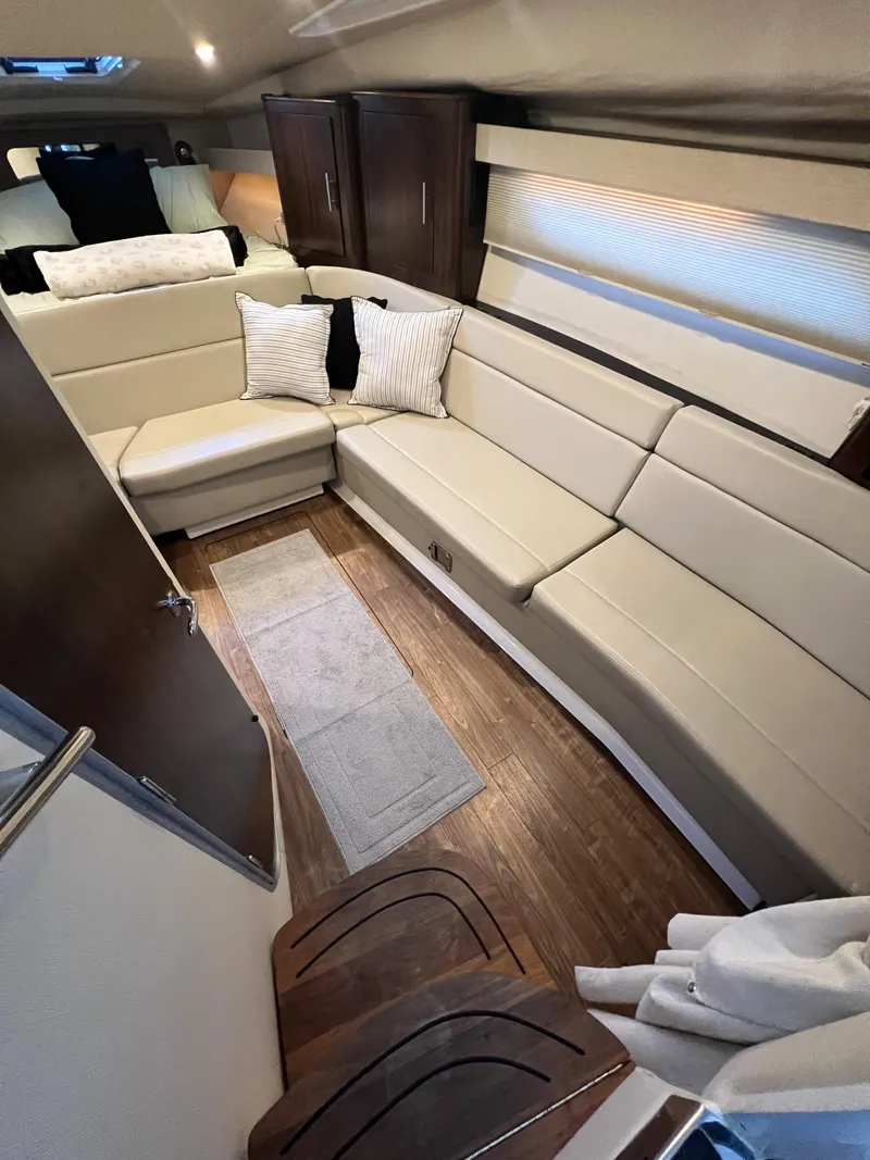 Slide: The Image of Interior of 2017 Regal 35 Sport Coupe with beige seating and wooden flooring. - 15