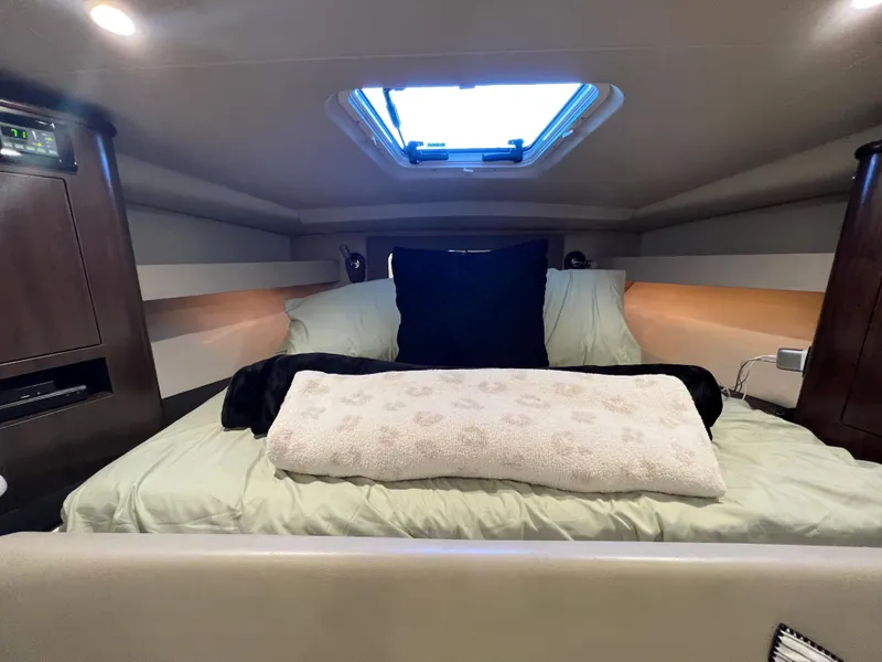 Slide: The Image of Interior of 2017 Regal 35 Sport Coupe with beige seating and bed. - 18