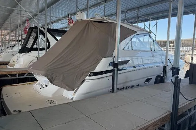 Slide: The Image of 2017 Regal 35 Sport Coupe docked under a covered marina. - 25