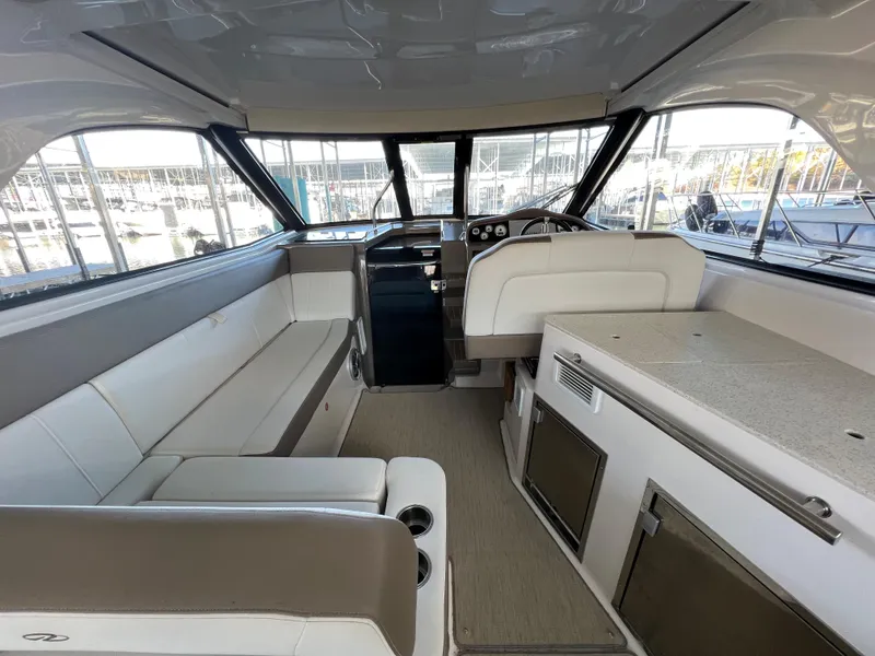 Slide: The Image of Interior of 2017 Regal 35 Sport Coupe yacht with seating and helm station. - 5