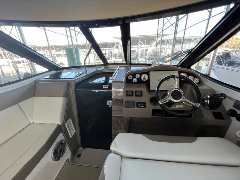 Slide: The Image of Interior helm of 2017 Regal 35 Sport Coupe with modern controls and seating. - 7