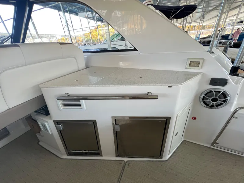 Slide: The Image of 2017 Regal 35 Sport Coupe yacht interior with kitchenette and seating area. - 9