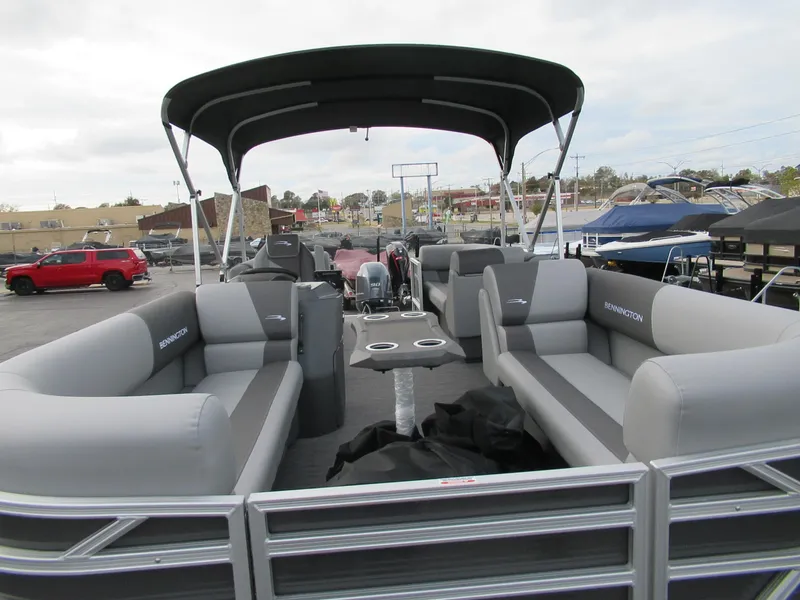 Slide: The Image of 2024 Bennington 20 SVSR pontoon boat with spacious seating and canopy. - 2