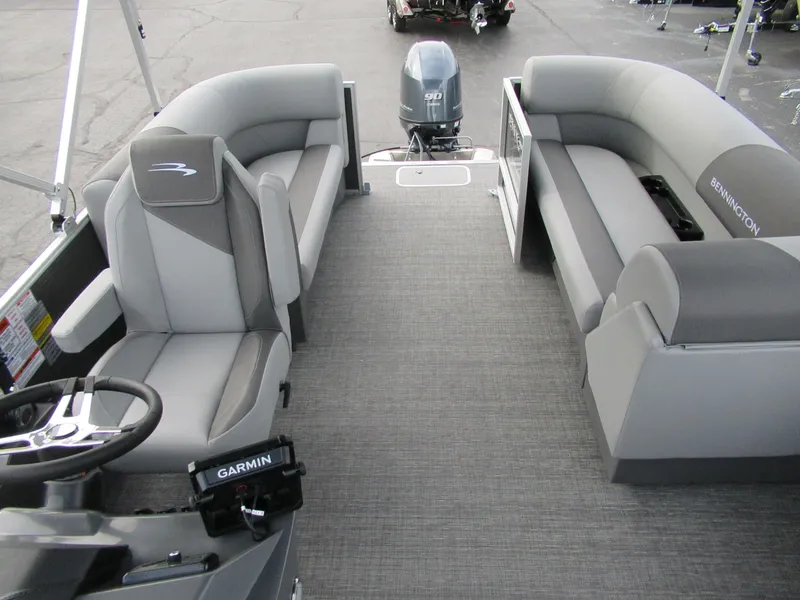 Slide: The Image of 2024 Bennington 20 SVSR pontoon boat interior with gray seating and Garmin navigation system. - 3