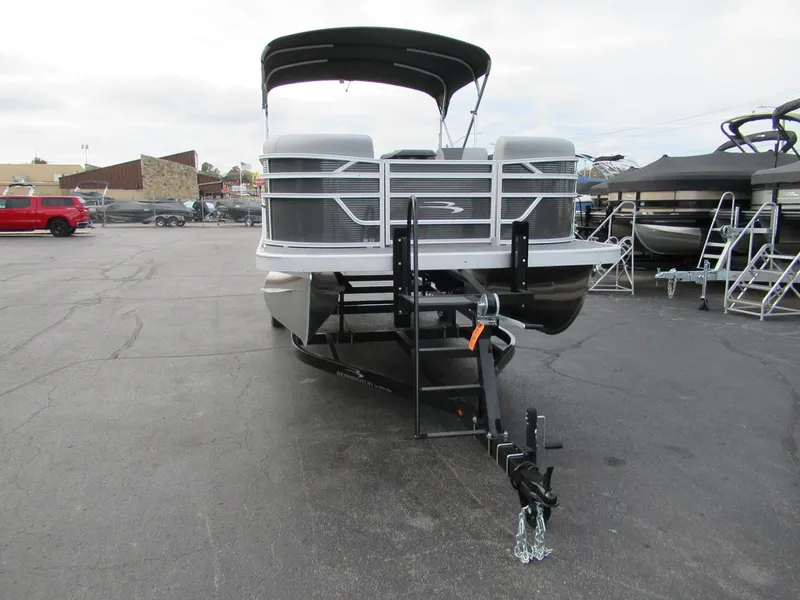 Slide: The Image of 2024 Bennington 20 SVSR pontoon boat on a trailer in a parking lot. - 4