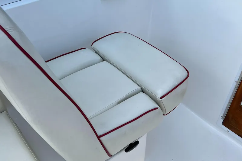 Slide: The Image of White cushioned seat with red trim on 2015 Hunt Yachts Harrier Sport. - 12