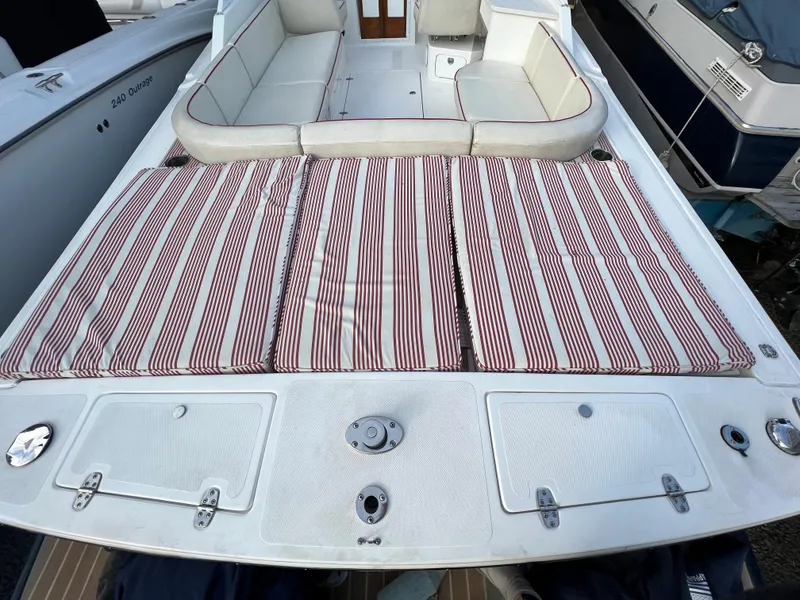 Slide: The Image of 2015 Hunt Yachts Harrier Sport with striped cushions and spacious seating area. - 5