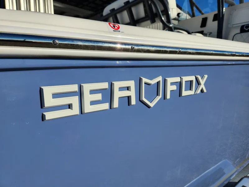 Slide: The Image of 2024 Sea Fox 248 Side Console boat logo on blue hull. - 10