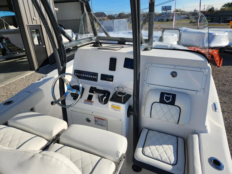 Slide: The Image of 2024 Sea Fox 248 Side Console boat interior with white seating and control panel. - 5