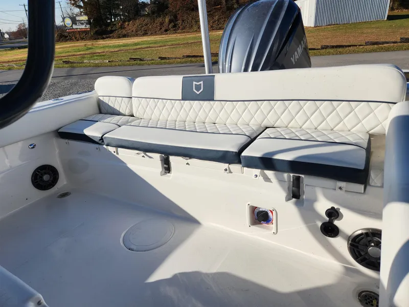 Slide: The Image of 2024 Sea Fox 248 Side Console boat interior with cushioned seating and Yamaha outboard motor. - 8