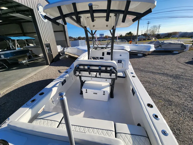Slide: The Image of 2024 Sea Fox 248 Side Console boat with T-top and seating, docked outdoors. - 9