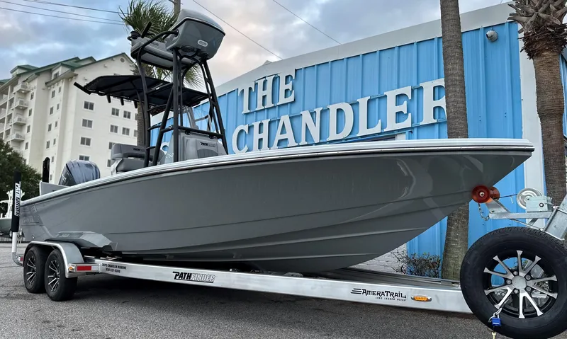 Slide: The Image of 2024 Pathfinder 2500 Hybrid boat on trailer in front of The Chandler building. - 2