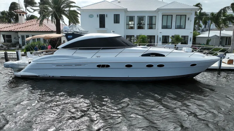 Slide: The Image of 2006 Neptunus 55 Cabrio yacht docked near waterfront homes. - 0