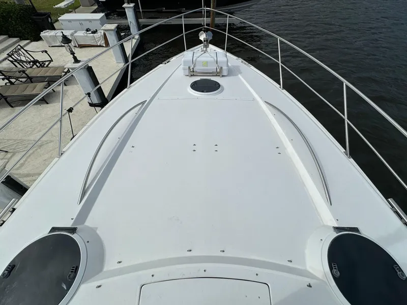 Slide: The Image of Bow view of 2006 Neptunus 55 Cabrio yacht docked by the water. - 11