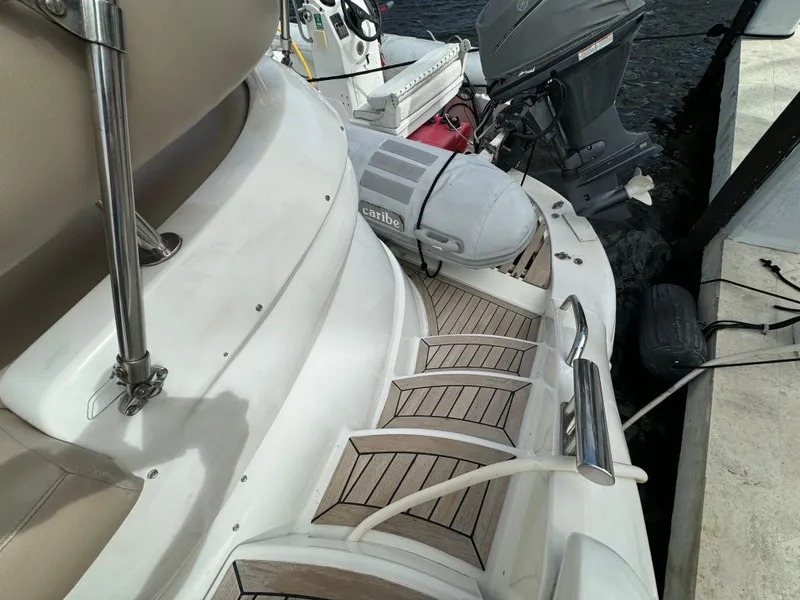 Slide: The Image of 2006 Neptunus 55 Cabrio yacht stern with wooden steps and outboard motor. - 13