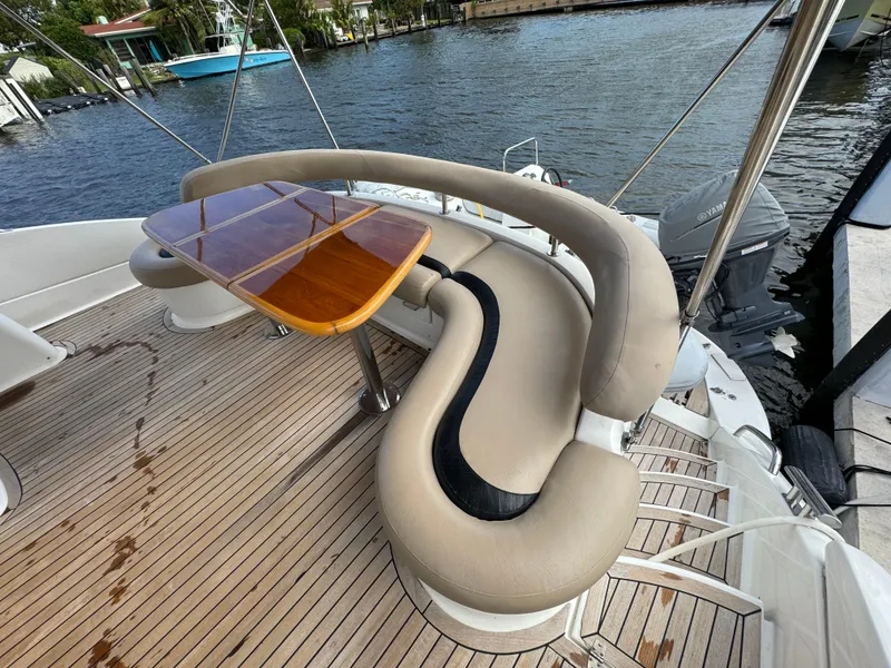 Slide: The Image of Curved seating and wooden table on 2006 Neptunus 55 Cabrio yacht deck. - 16