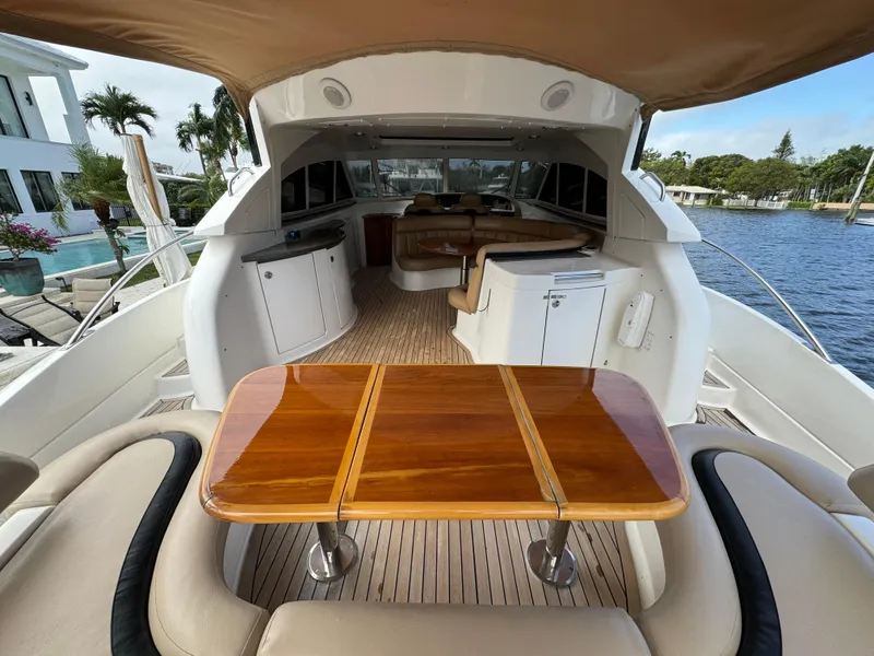 Slide: The Image of 2006 Neptunus 55 Cabrio yacht interior with wooden table and seating. - 18