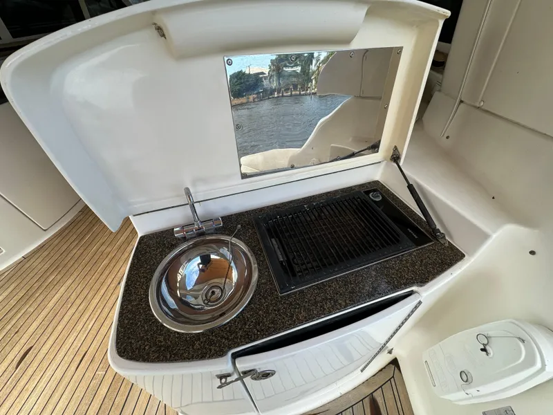 Slide: The Image of Outdoor kitchen on a 2006 Neptunus 55 Cabrio yacht with sink and grill. - 20