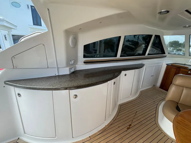 Slide: The Image of Interior of 2006 Neptunus 55 Cabrio yacht with sleek cabinetry and wooden flooring. - 23