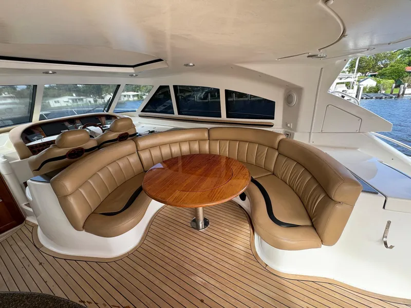 Slide: The Image of Luxurious interior of a 2006 Neptunus 55 Cabrio yacht with leather seating and wooden table. - 24