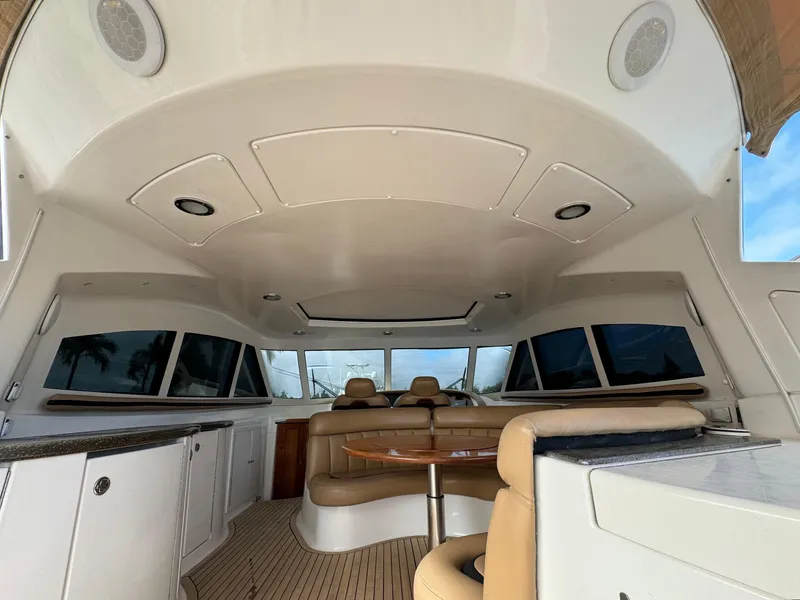 Slide: The Image of Interior of 2006 Neptunus 55 Cabrio yacht with beige seating and wooden table. - 25
