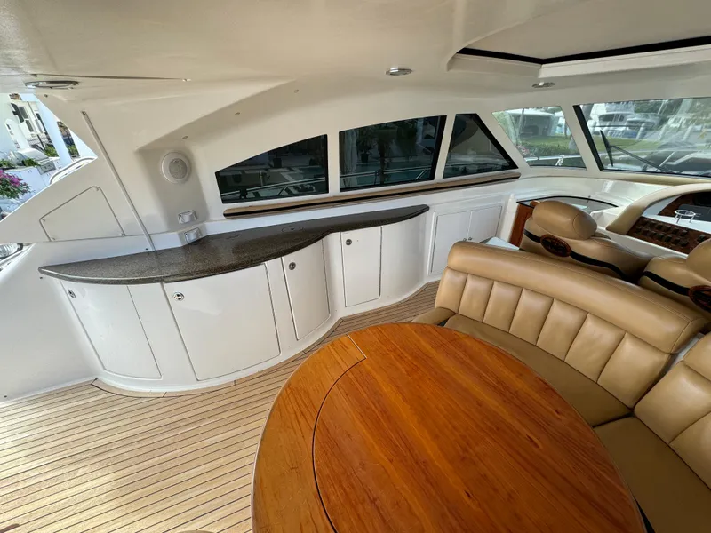 Slide: The Image of Interior of 2006 Neptunus 55 Cabrio yacht with seating and wooden table. - 26