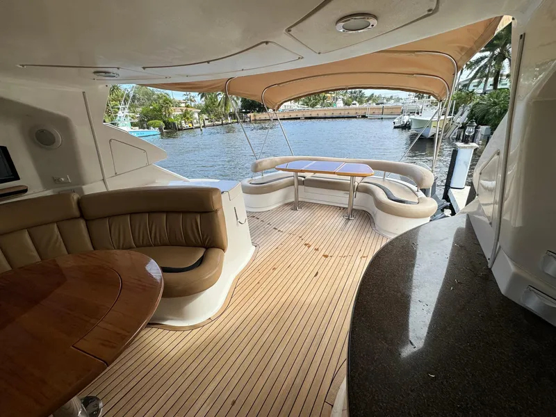 Slide: The Image of Luxury deck of 2006 Neptunus 55 Cabrio yacht with seating and table. - 28