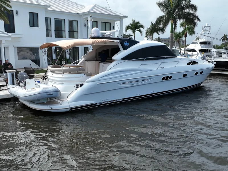 Slide: The Image of 2006 Neptunus 55 Cabrio yacht docked near waterfront homes. - 3