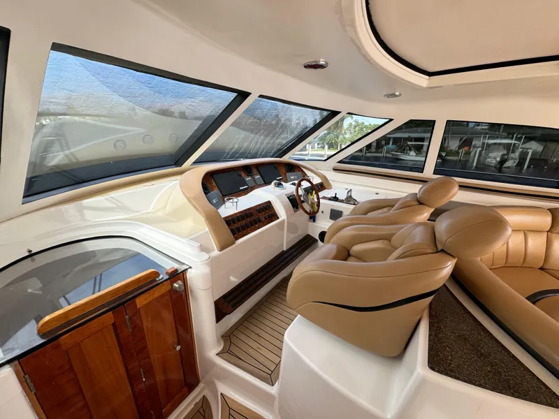 Slide: The Image of Interior of 2006 Neptunus 55 Cabrio yacht with leather seating and wooden accents. - 30